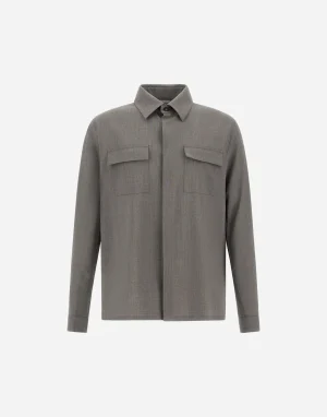 Gray long-sleeve button-up shirt with a collar and two front chest pockets on a plain background.