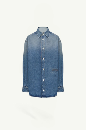 Blue denim long-sleeve button-down shirt jacket with a classic collar and visible white buttons on a plain light background.