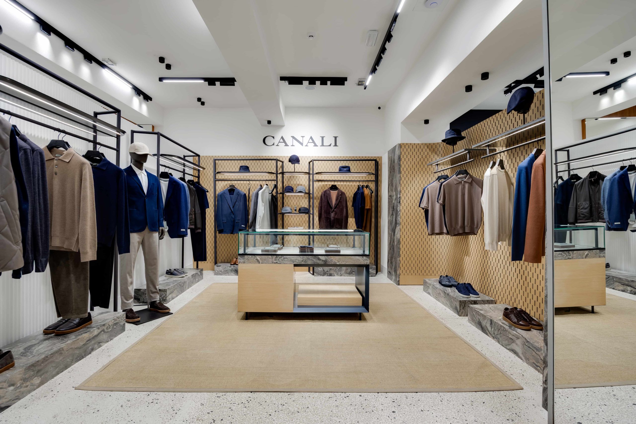 Canali men's fashion store interior with suits on mannequins and hats on shelves in a bright boutique