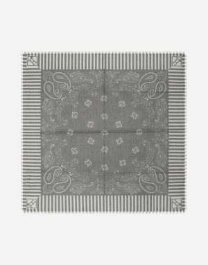 Gray square bandana laid flat, showing a paisley border and striped edges with corner logos, and a central floral motif.