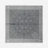 Gray bandana with paisley and floral patterns, bordered by vertical stripes and fringed edges.