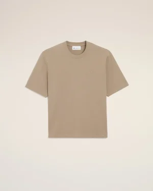 Beige short-sleeve crewneck T-shirt laid flat on a pale background, with a small chest emblem.