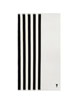 Abstract white canvas with seven vertical black stripes along the left edge; small heart and 'A' signature at bottom-right.