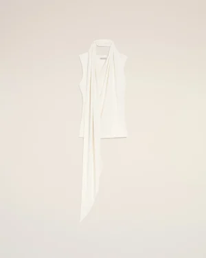 White scarf draped over a hanger against a pale beige background in a minimalist display
