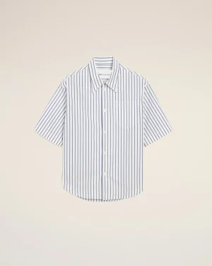 White button-down shirt with blue vertical stripes displayed against a pale beige background, centered in the frame.