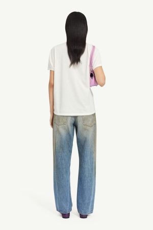 Back view of a person wearing a white T-shirt and loose blue jeans, carrying a pink handbag over the shoulder.