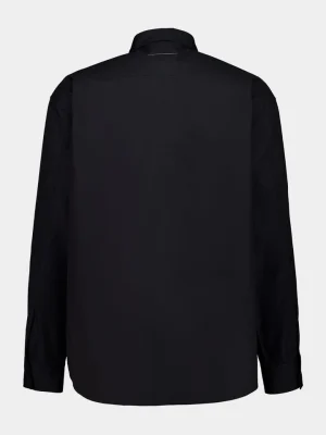 Back view of a plain black long-sleeve collared shirt with no visible prints or patterns