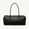 Black leather duffel bag with two rounded top handles and a top zipper closure, minimal branding on the front