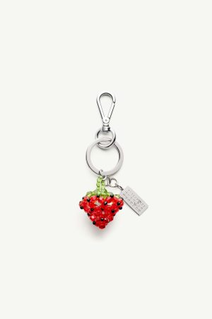 Silver keychain with a beaded red strawberry charm and green leaves, plus a small metal tag.