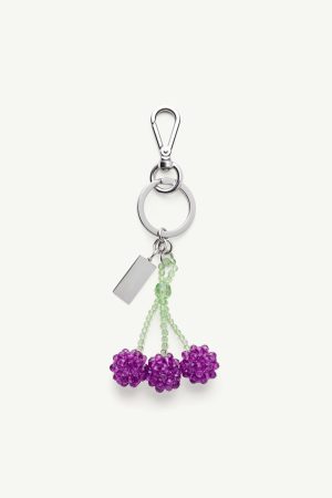 Silver keychain featuring a lobster-claw clasp, a large ring, a hanging lime-green bead stem with three purple bead flowers and a rectangular metal tag.