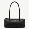 Black leather handbag with two top handles and a zip closure, minimalist design.