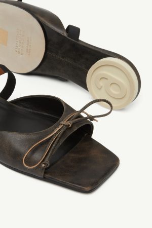 Dark brown leather open-toe sandals with a lace bow, shown from the front and side edges.