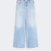 Light blue faded wide-leg denim jeans with five pockets and belt loops on a neutral background.