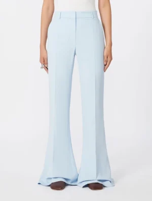 Light blue wide-leg trousers with front creases, full length, paired with brown shoes