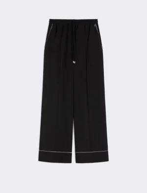 Black wide-leg pants with a drawstring waist and white piping along the hem.