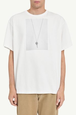 White T-shirt with a grey rectangular graphic showing a delicate silver key pendant on a chain.