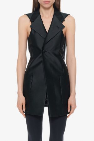 Black sleeveless tailored vest with wide overlapping lapels, single button closure, and front pockets on a model.