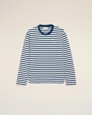 Striped navy and white long-sleeve shirt displayed against a light beige background, chest logo subtly visible.