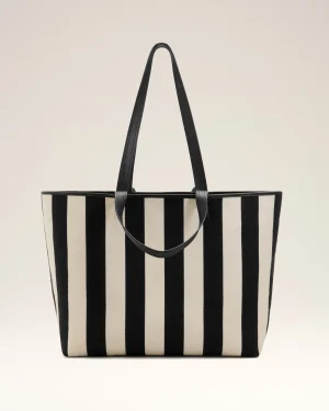 Large striped tote bag with black handles, beige and black vertical stripes against a pale background.