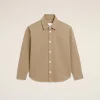 Beige button-down shirt with a stitched bear outline on the left chest.