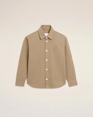 Beige button-down shirt with a stitched bear outline on the left chest.
