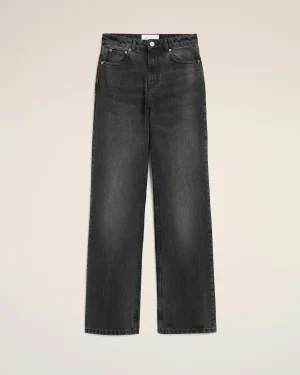 Pair of dark-wash jeans laid flat, front view with pockets and button fly visible on a beige background to showcase the denim pants.