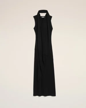 Long black sleeveless dress with a draped scarf around the neck, displayed against a light beige background.