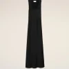 Long black sleeveless dress with a deep V-neck displayed against a pale beige background.
