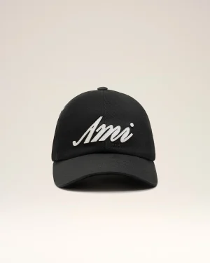Black curved-brim baseball cap facing forward with white cursive lettering on the front panel against a pale background, close-up view