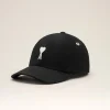Black baseball cap with white embroidered letter A and heart on the front panel