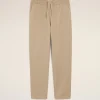 Beige casual trousers with an elastic waistband and drawstring, featuring slanted side pockets.