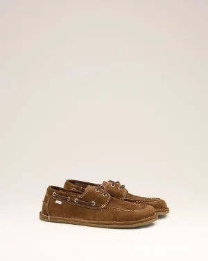Pair of brown suede moccasin-style boat shoes with white stitching on a light background.