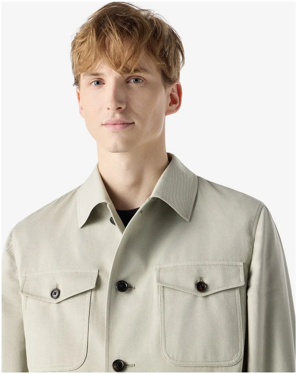 IMG_1584 - New Trend Young man wearing a light beige button-front jacket with large flap pockets and dark buttons.