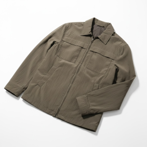 Khaki utility jacket with a front zipper and four pockets laid flat on a white background, view from above.