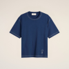 Blue short-sleeve T-shirt with white topstitching, shown from the chest to hem against a light background."The stitching around the crew neck and sleeves is visible."