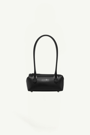 Small black leather handbag with two short handles, centered against a pale background.