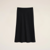 A black knee-length skirt with a ribbed elastic waistband against a light beige background.