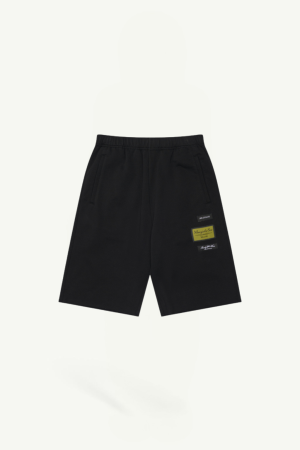 Black athletic shorts with an elastic waistband and side pockets, featuring small patches on the right leg