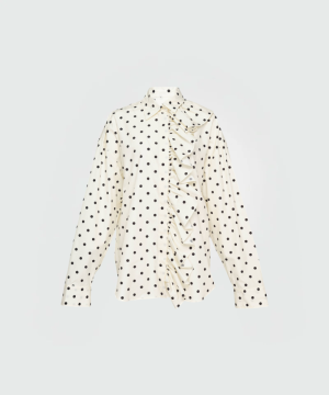 Cream polka-dot blouse with a ruffled front and button placket along the left side.