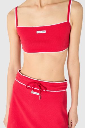 Red ribbed bikini top with white piping along edges and straps, small MARINE SERRE label on the front.