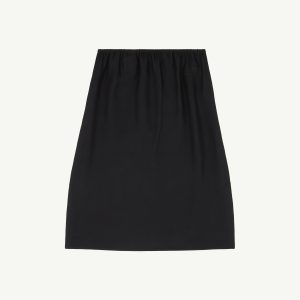 Black skirt viewed from the waist down, featuring an elastic waistband and smooth drape.