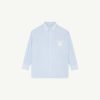 Front view of a light blue striped dress shirt with a pointed collar and visible buttons against a pale background.
