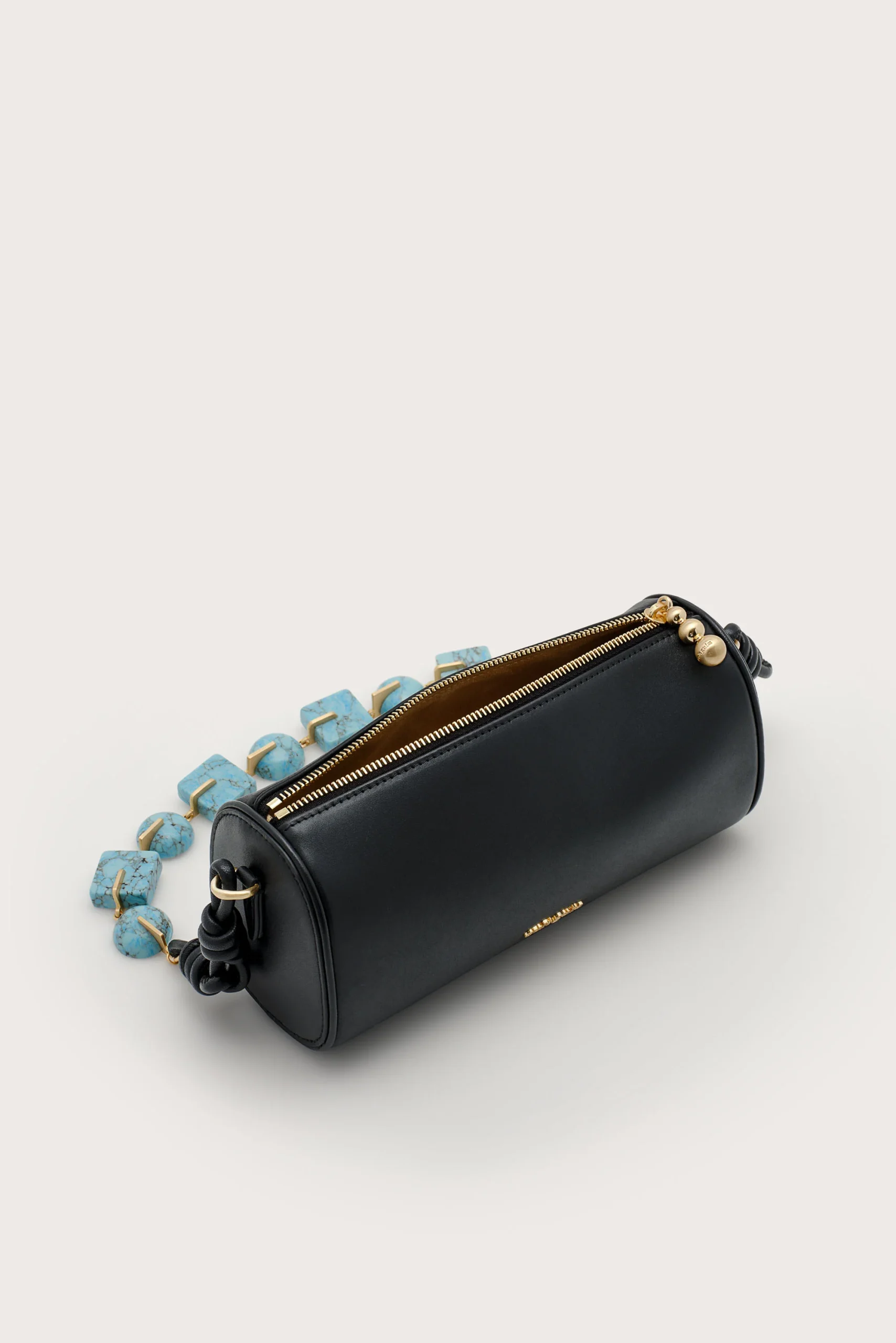 IMG_1293 - New Trend Black leather clutch with a gold zipper and turquoise bead strap on a light background