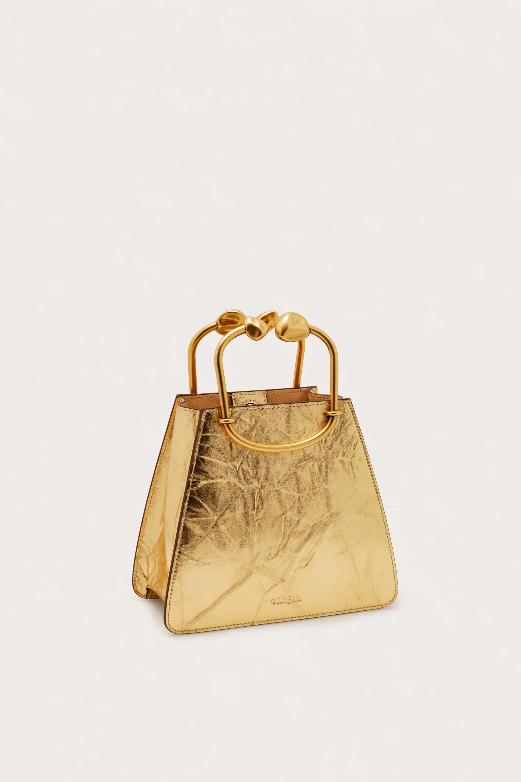 IMG_1295 - New Trend Gold metallic handbag with large rounded gold handles against a light background.