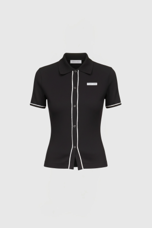 Black short-sleeve polo dress with white piping along the front placket and sleeve hems; Marine Serre label visible on chest