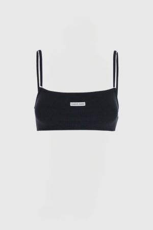 Black ribbed crop top with thin spaghetti straps on a mannequin, featuring a small Marine Serre label at center.