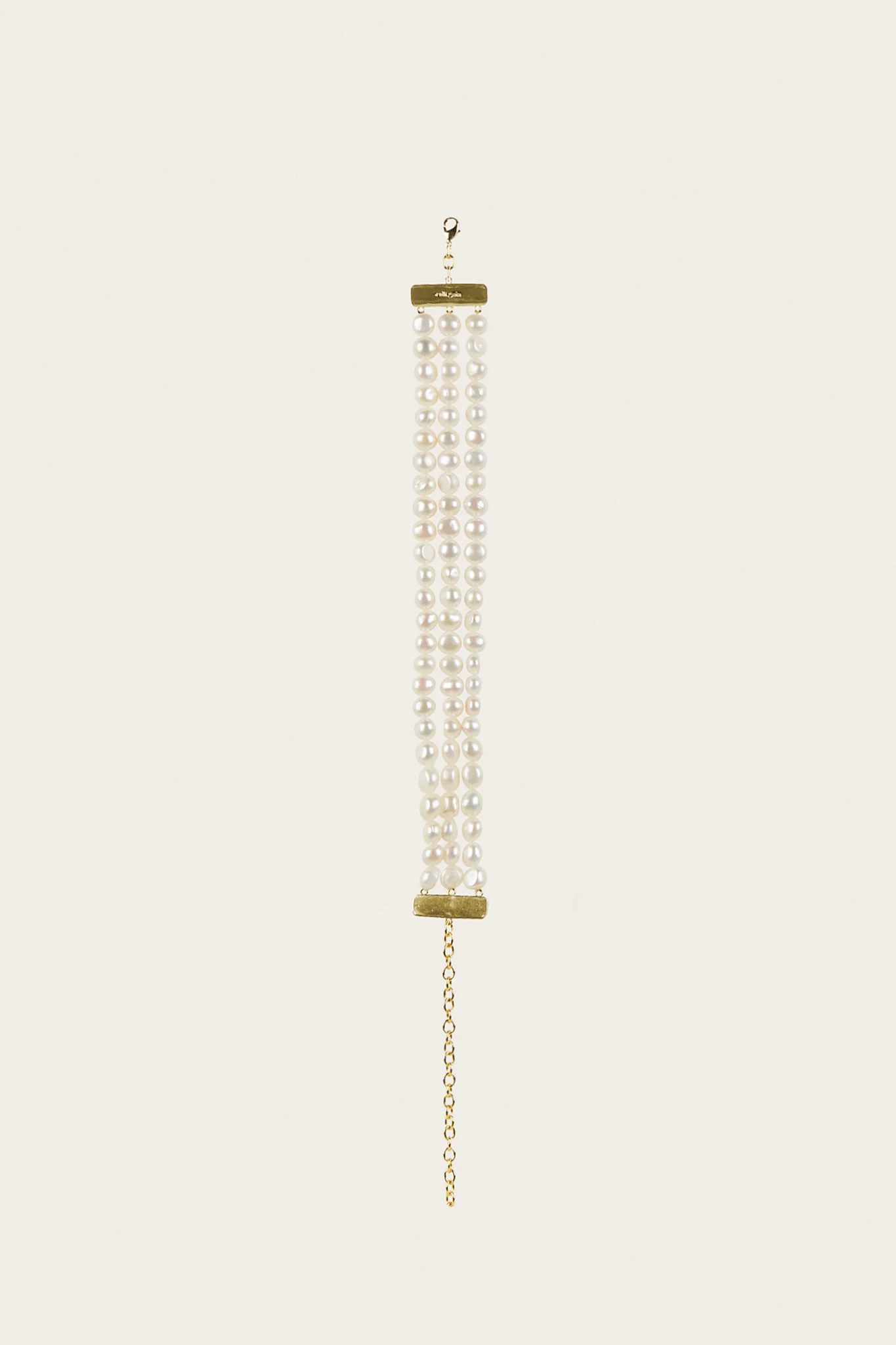 IMG_1401 - New Trend Threaded pearl necklace with several white pearl strands hanging from a gold clasp against a pale background