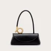 Black leather handbag with a curved black strap and a gold ring accent on the top.