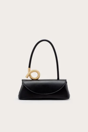 Black leather handbag with a curved black strap and a gold ring accent on the top.