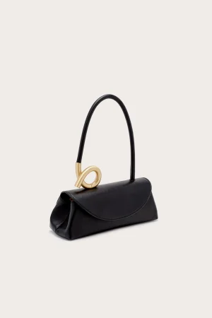 Elegant black leather handbag with a curved gold-tone decorative clasp and top handle on a light background.